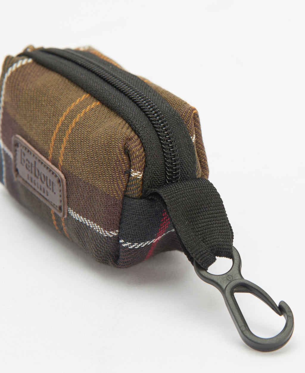 Tartan poop bag dispenser close-up with textured fabric and metal carabiner clip