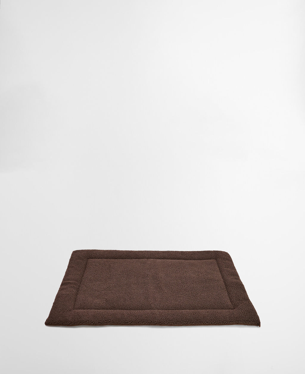 Brown fleece-lined dog mat with raised padded rim