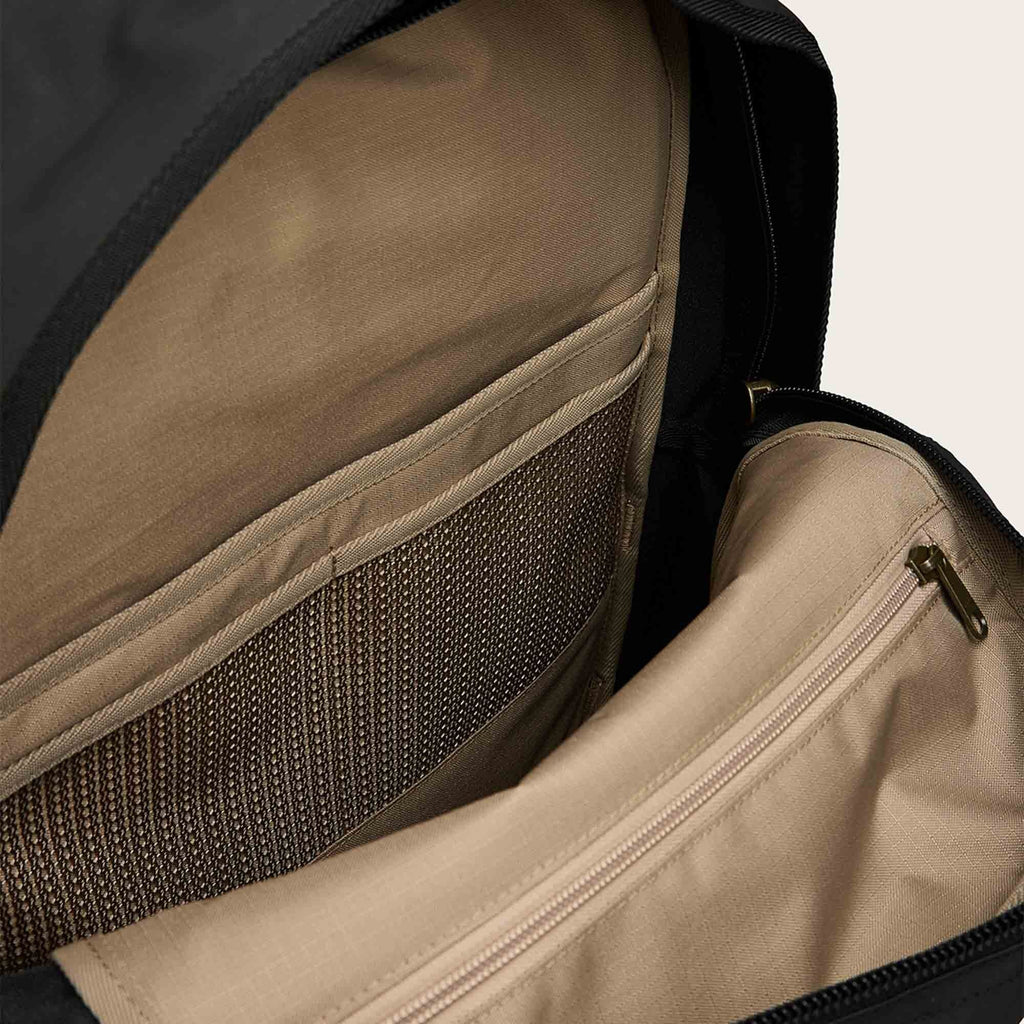 Scout Journey backpack interior, tan lining with zip pocket and fabric panels.