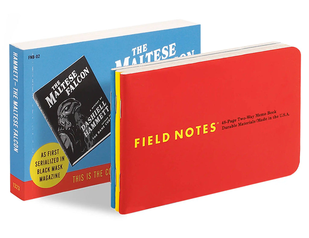 Stacked books showing a red “Field Notes” cover and a blue book behind it.