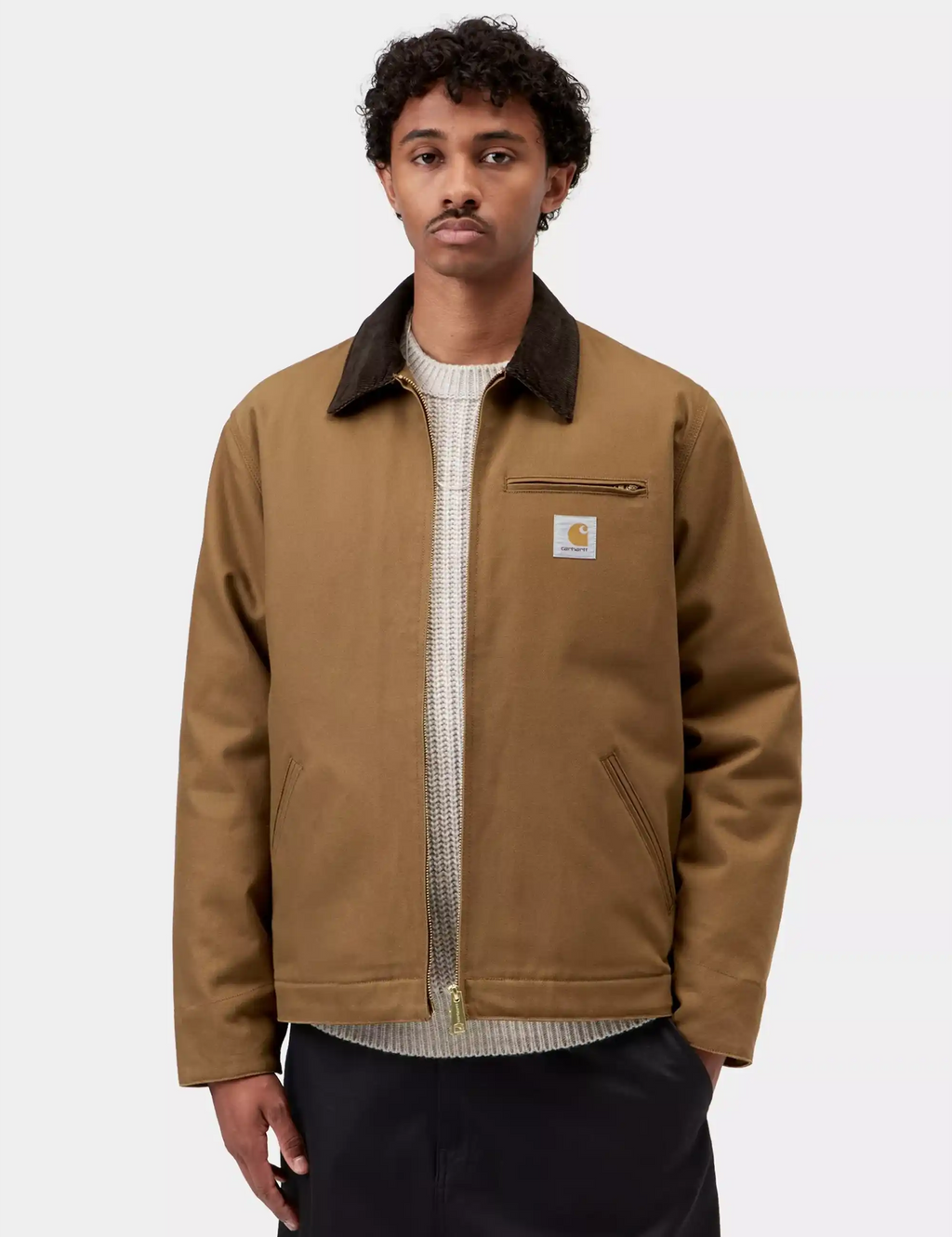 Men's winter jacket in tan with dark collar, zip closure, logo patch on chest
