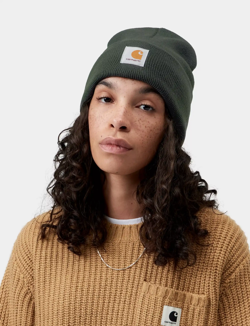 Dark green acrylic watch beanie hat with Carhartt logo patch and fold-up cuff