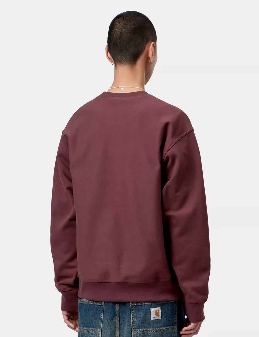 Maroon crewneck sweatshirt, plain back view with long sleeves and ribbed cuffs
