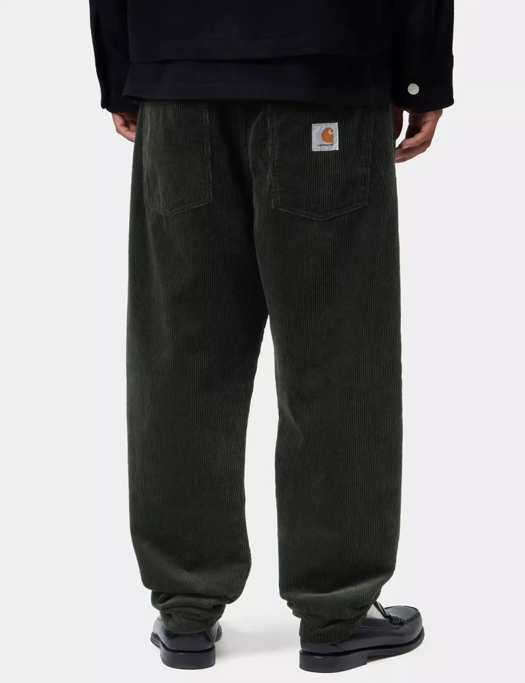 Dark corduroy pants with back patch pockets and logo tag near waistband