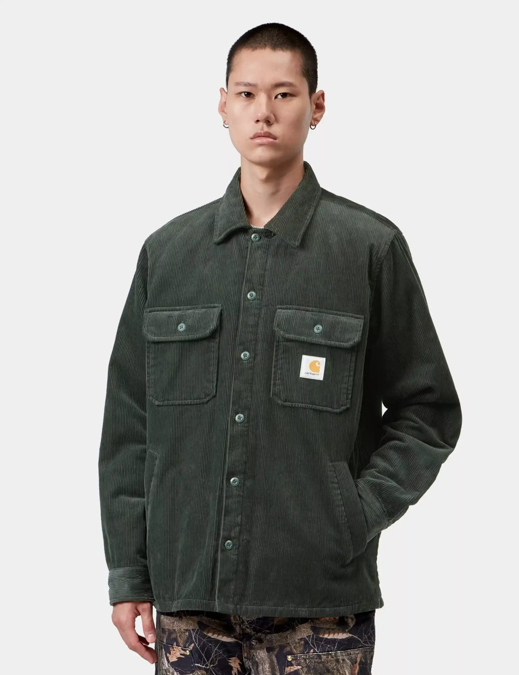 Dark green shirt-jacket with point collar, two chest pockets, and Carhartt WIP patch