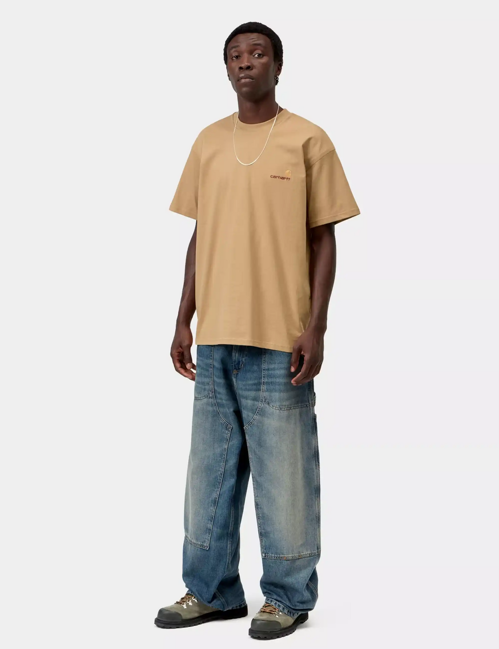 Carhartt WIP dusty tan T-shirt on model with chest logo, crew neck, short sleeves