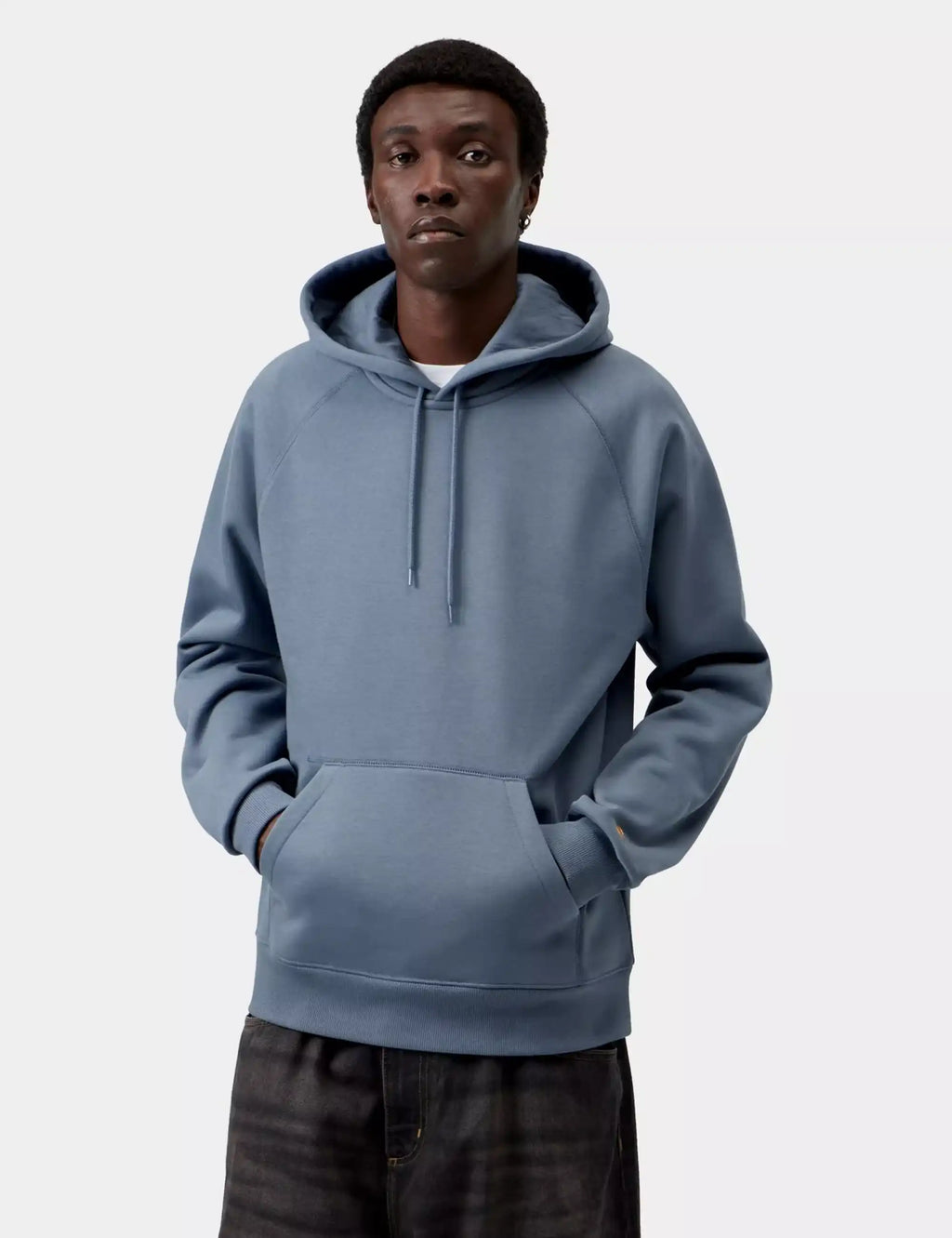 Ice-blue pullover hooded sweatshirt on model, drawstring hood and front kangaroo pocket.