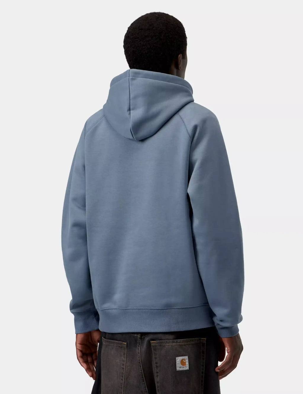 Ice-blue pullover hooded sweatshirt back view on model, long sleeves and ribbed hem.