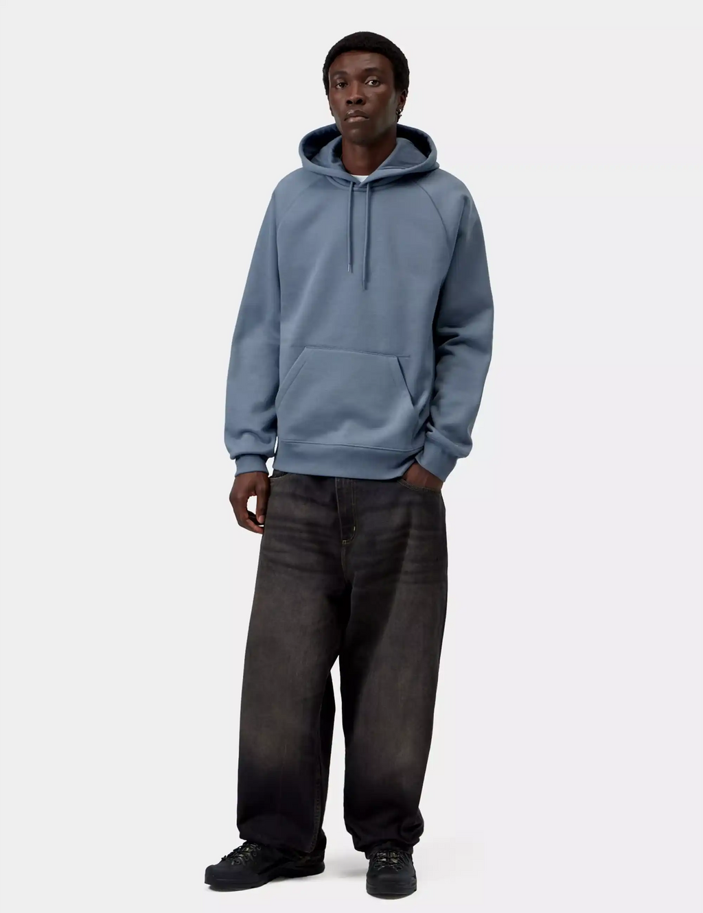 Ice-blue hooded sweatshirt on model with drawstring hood and front kangaroo pocket.