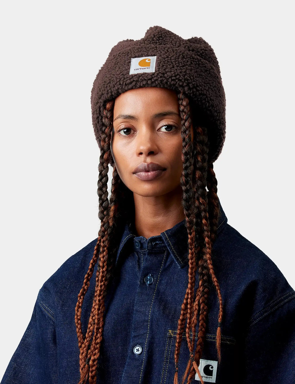 Dark brown sherpa beanie hat with inner ear flaps and woven label patches