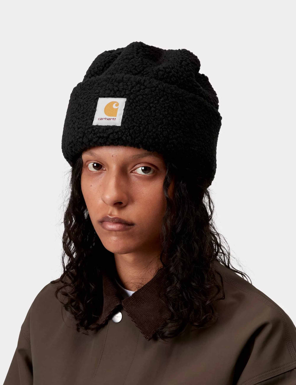 Black sherpa beanie hat with Carhartt logo patch, worn by model