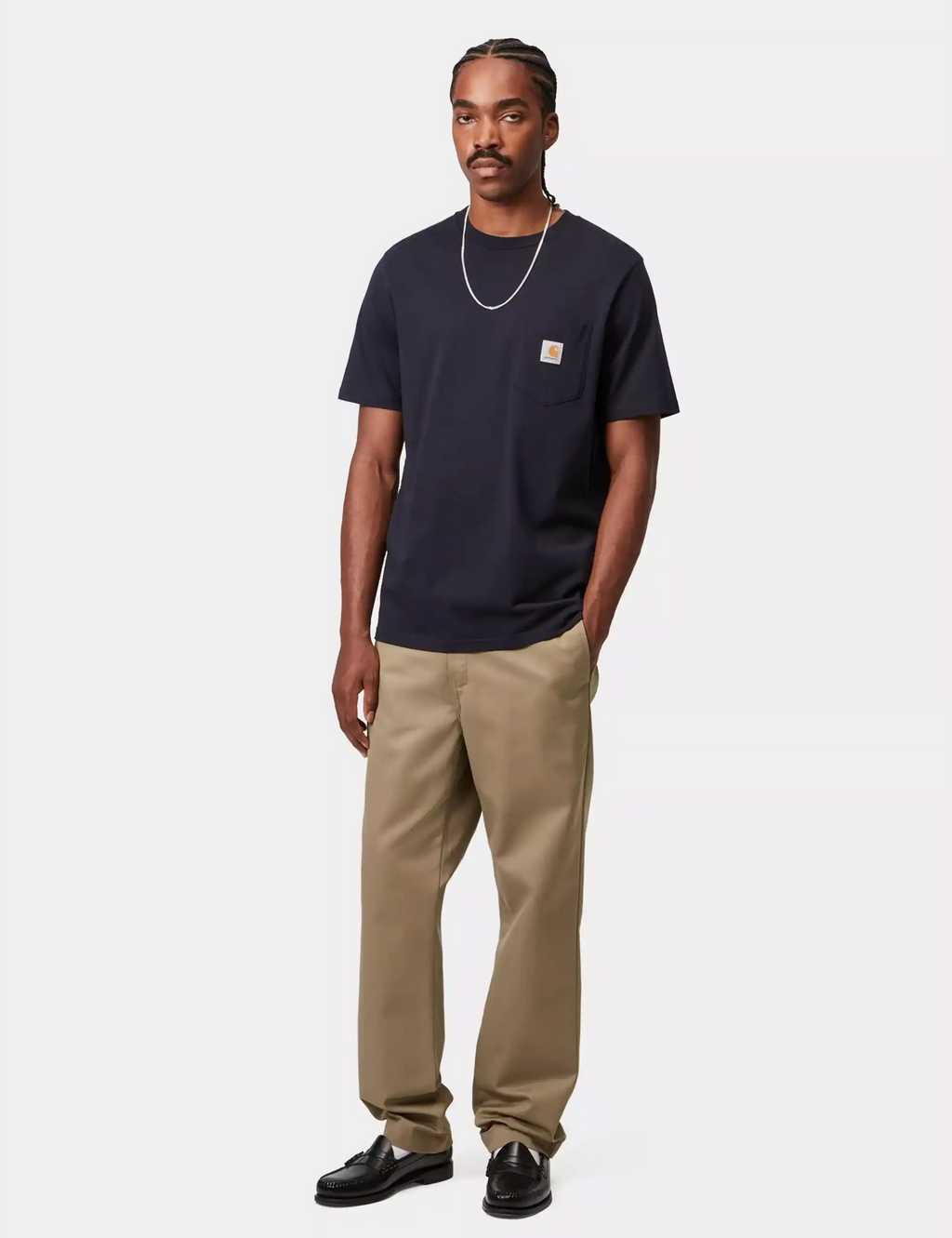 Beige leather pants worn with a dark shirt; front pockets and belt loops