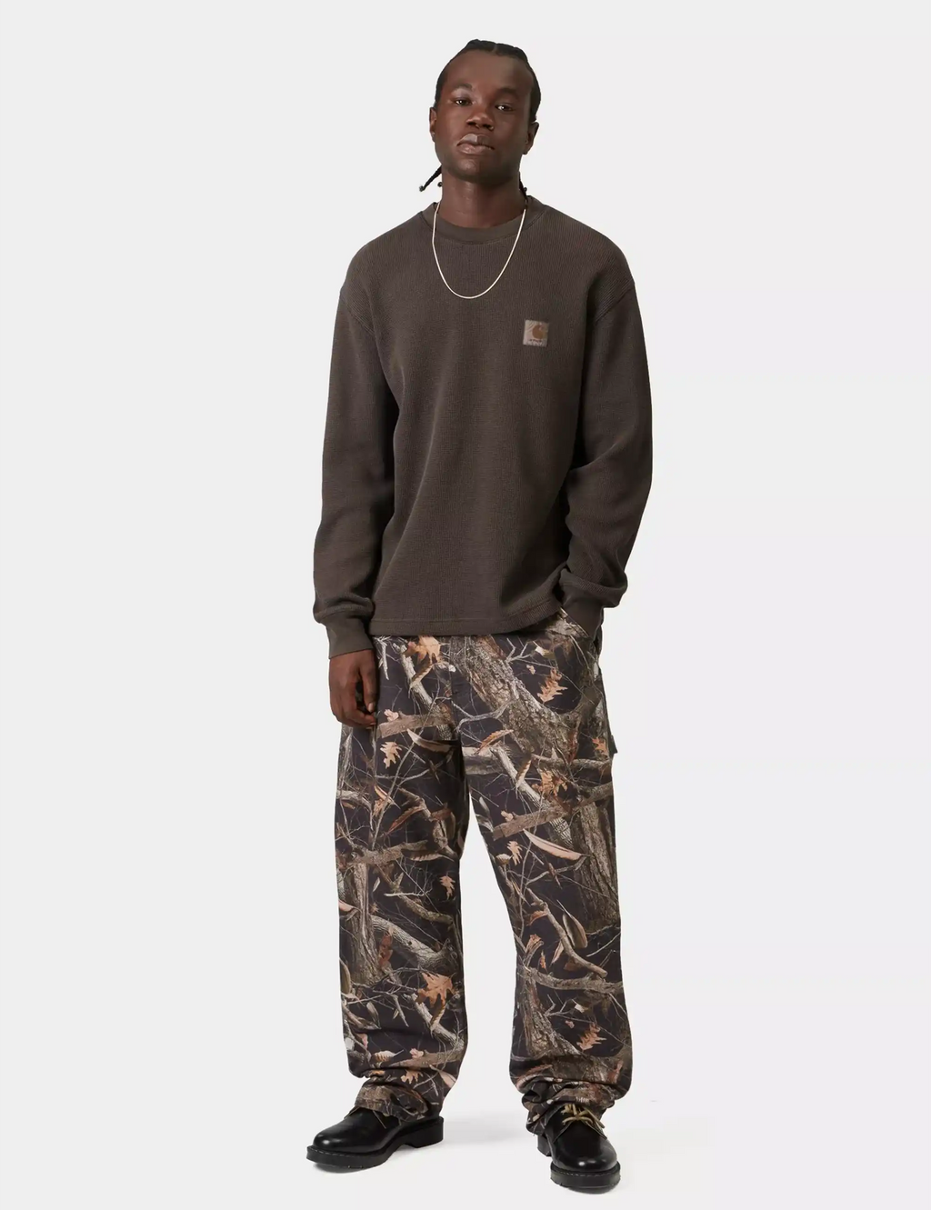Dark brown long-sleeve waffle t-shirt worn with patterned pants