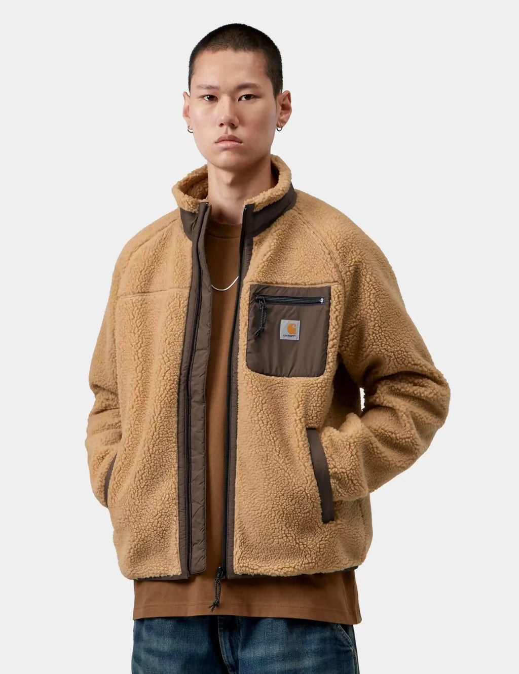 Tan sherpa fleece jacket with dark zip front, chest pocket, and side pockets