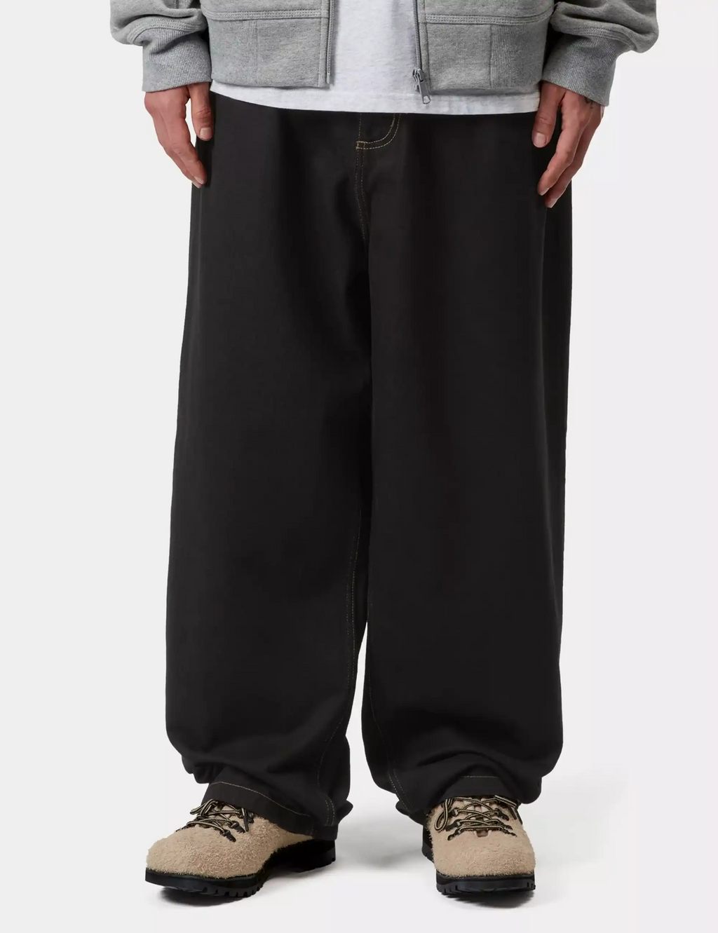Black denim pants with loose fit, gathered cuffs, and contrast topstitching