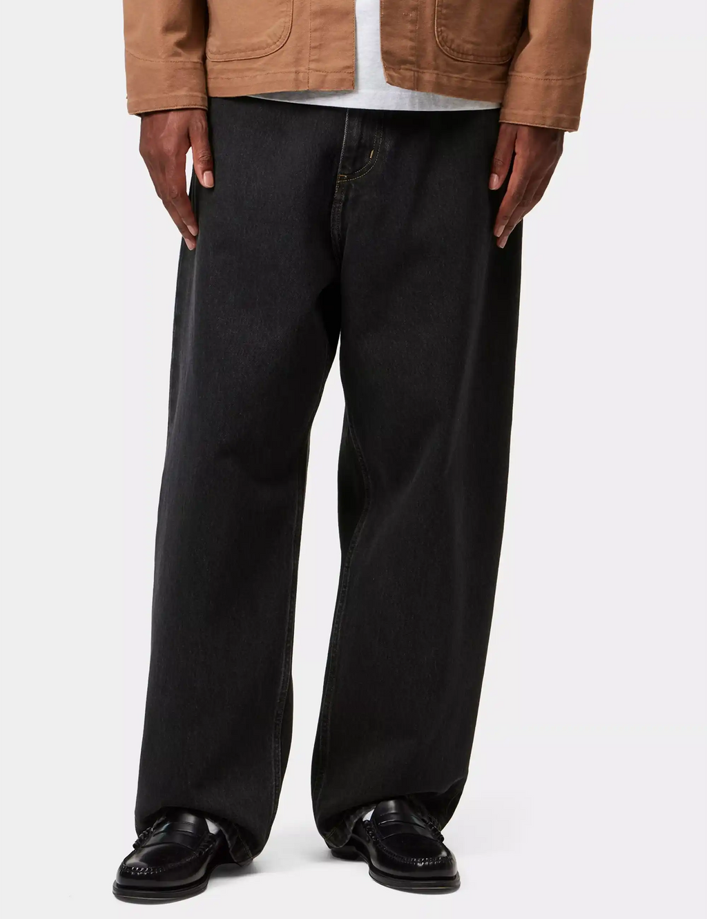 Black stone-washed denim pants on model, relaxed straight legs, front pockets