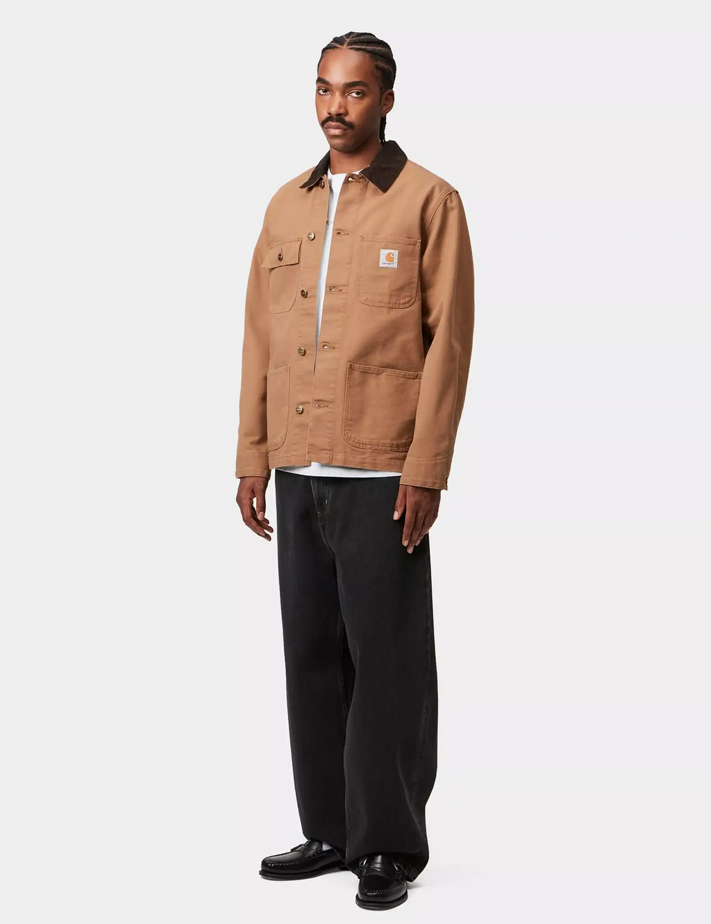 Black stone-washed denim pants on model, relaxed fit with button waist and cuffs