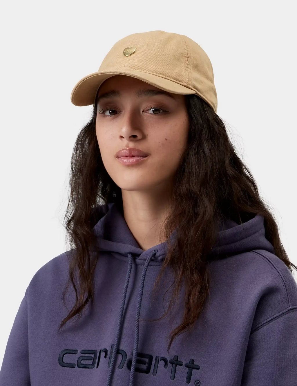 Beige baseball cap with metal heart logo on crown