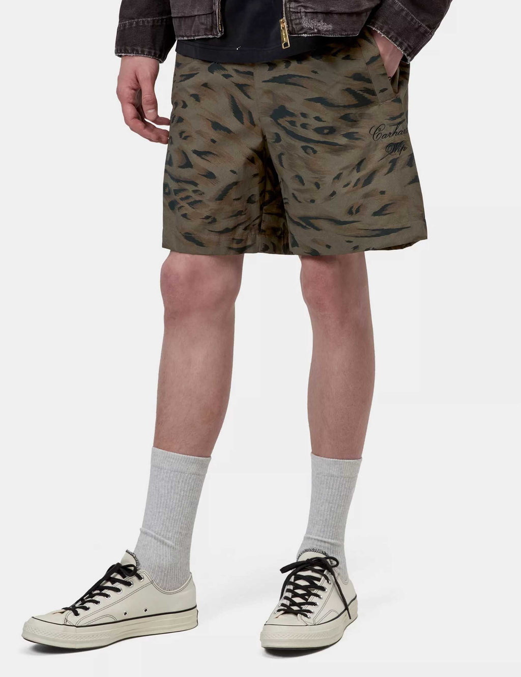 Men's printed above-knee shorts, olive with dark duck-feather pattern, side view