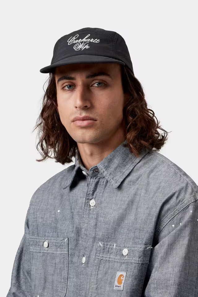 Carhartt WIP Travon cap, black wax fabric with white script logo on front, curved brim