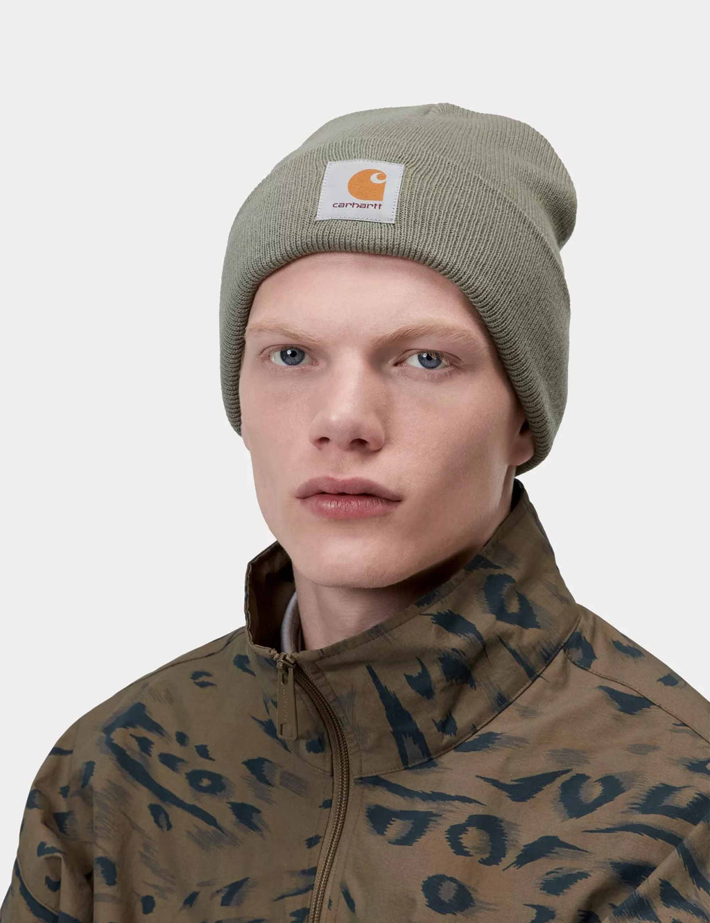 Watch hat in dark green knit worn on a model, Carhartt label on cuff