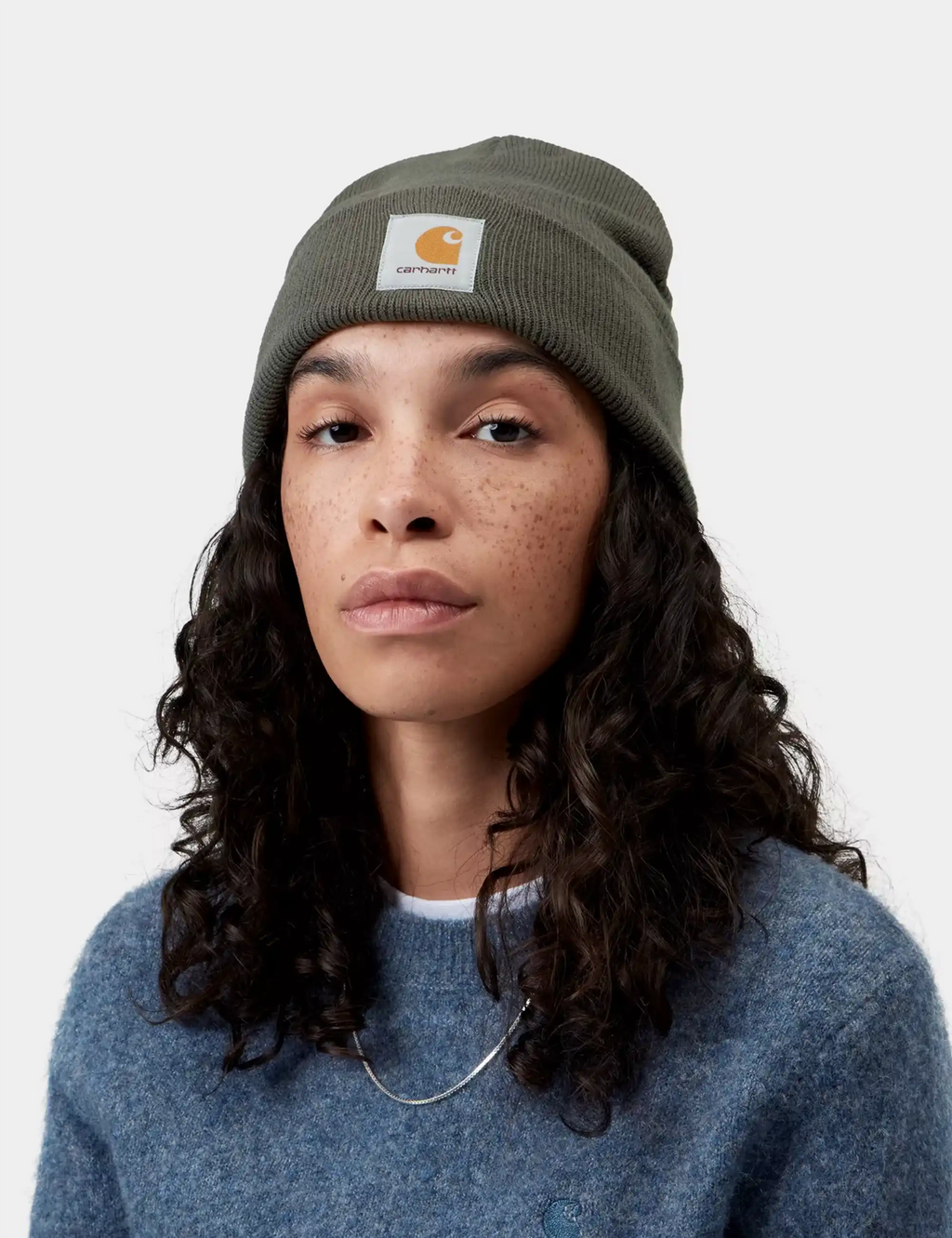 Olive knit watch cap beanie with Carhartt logo patch, worn on model