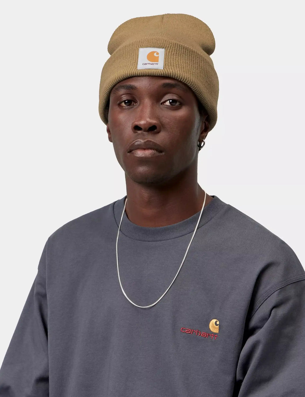 Brown short watch hat with ribbed cuff and Carhartt logo patch