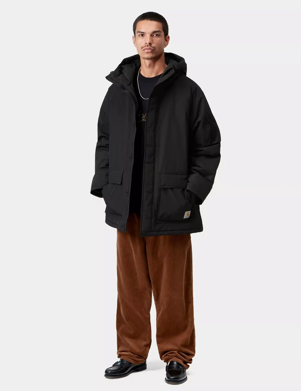Black parka worn with hood up; relaxed fit, quilted-style front pockets