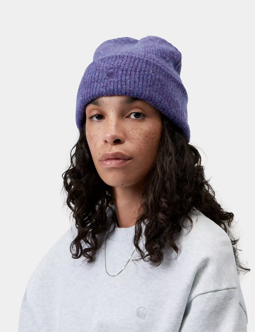 Shady purple knit beanie hat worn with rolled cuff