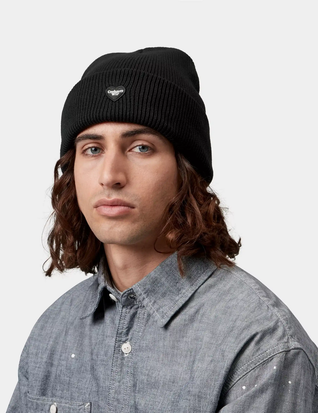 Black knit beanie hat with small heart logo badge
