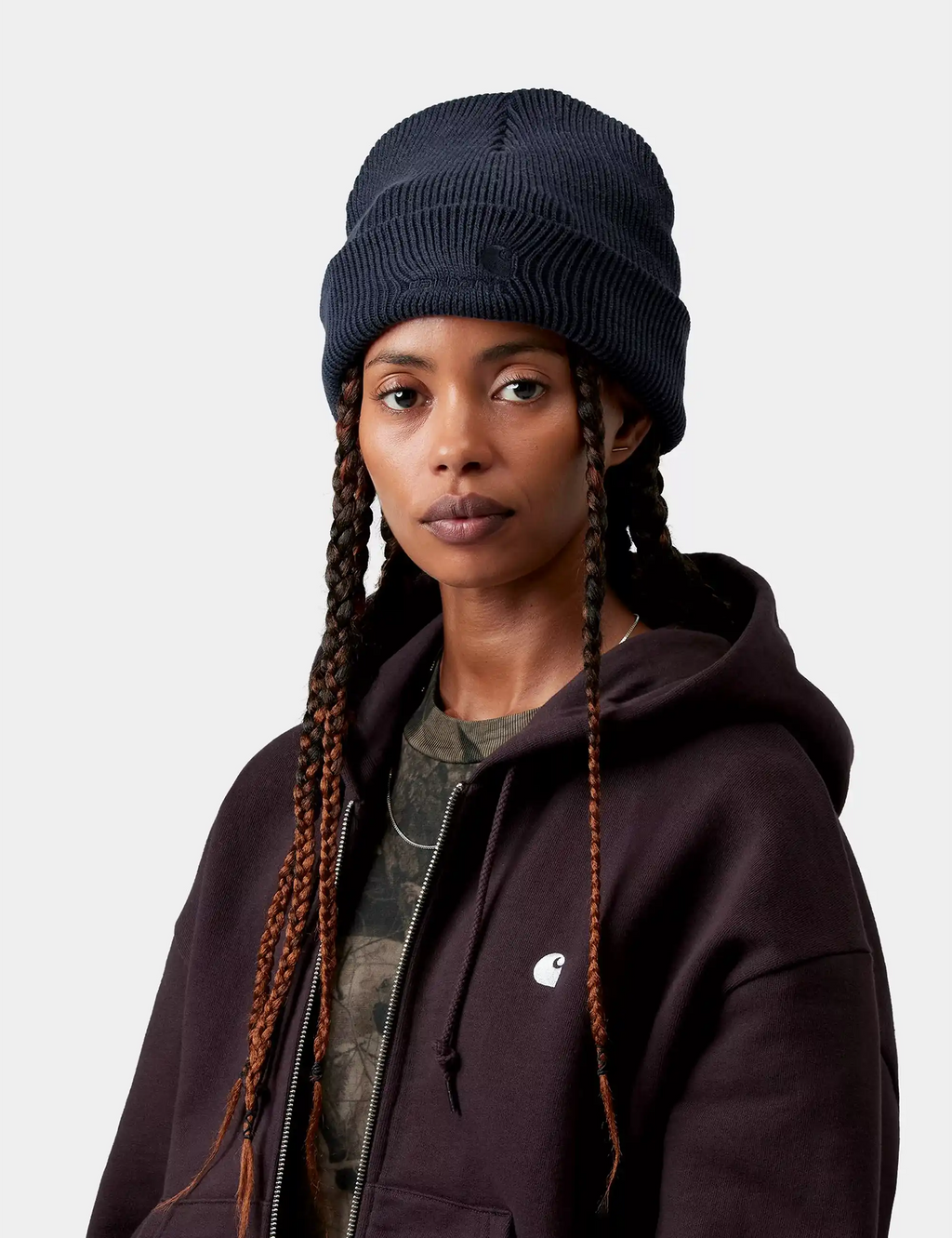 Dark navy ribbed beanie hat with folded cuff, worn with braided hair