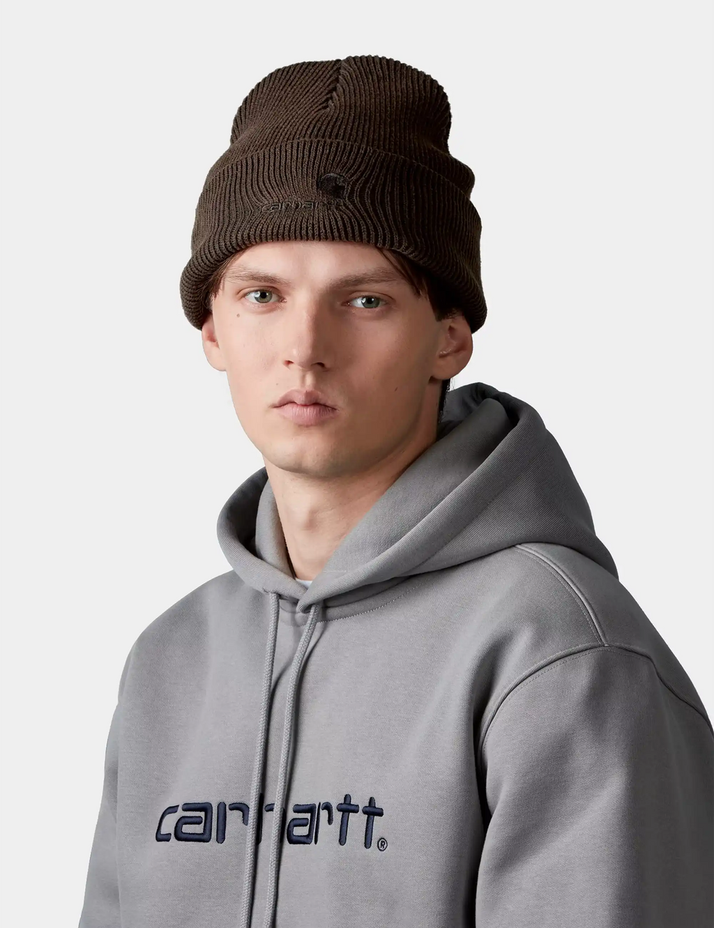 Tobacco-brown ribbed knit beanie with folded cuff and Carhartt logo