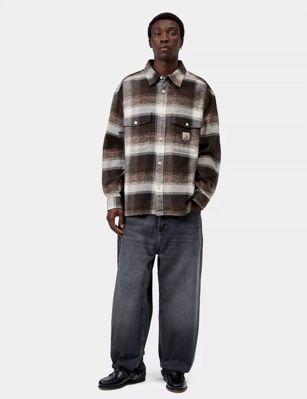 Plaid button-up work shirt with button front and chest pockets worn with dark jeans