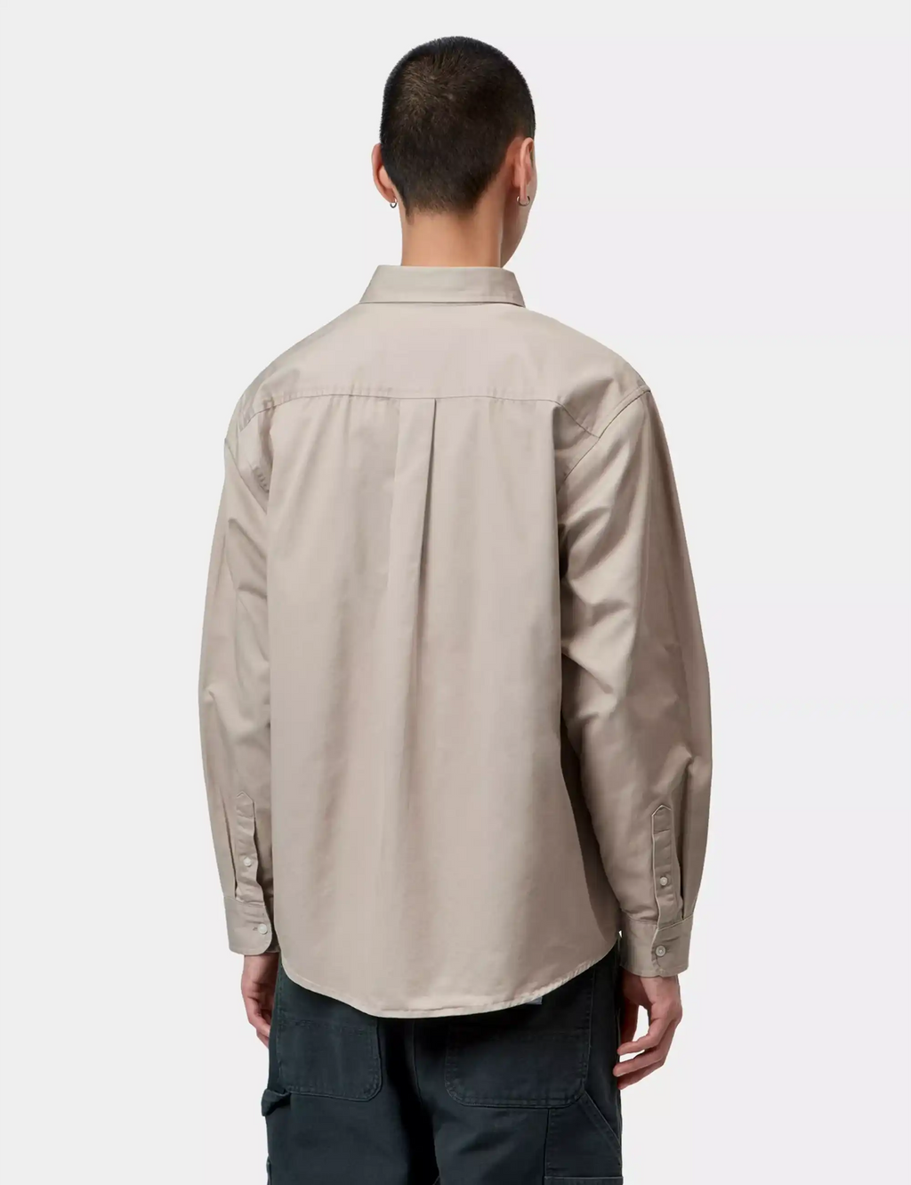 Light beige button-up shirt back with yoke seams and long sleeves.