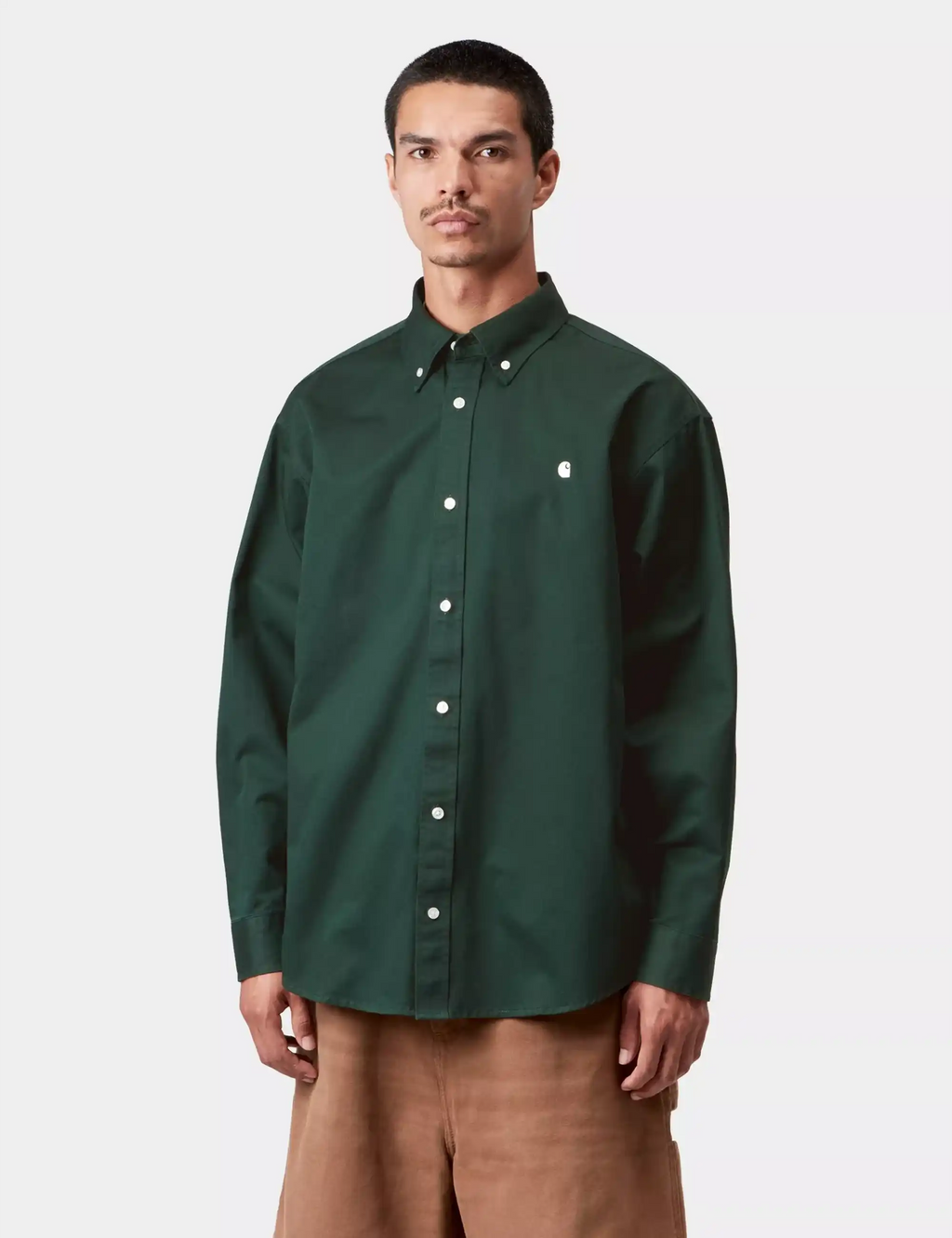 Dark green button-up long-sleeve shirt on model, pointed collar and front buttons