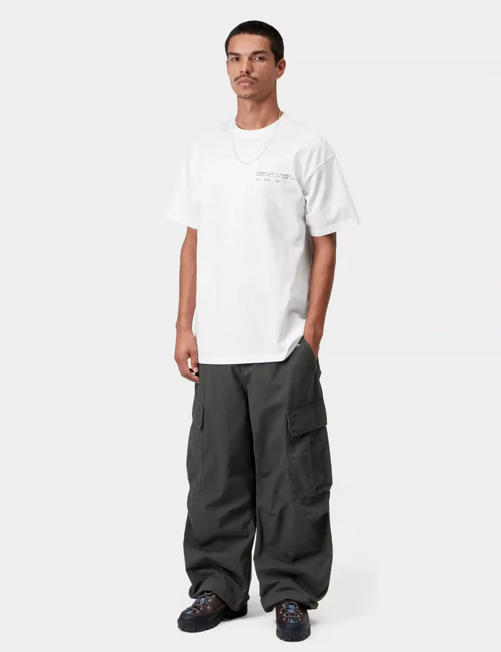 White crew-neck T-shirt with small chest print and straight hem.
