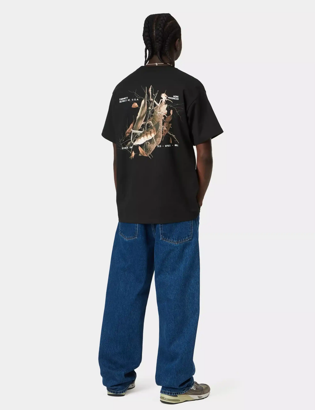 Black crewneck T-shirt with large animal graphic on back, model full view