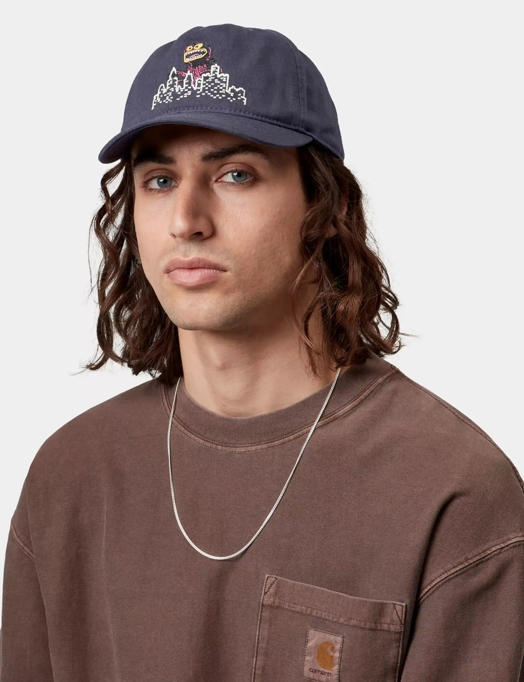 Dark purple baseball cap with front graphic patch and curved brim