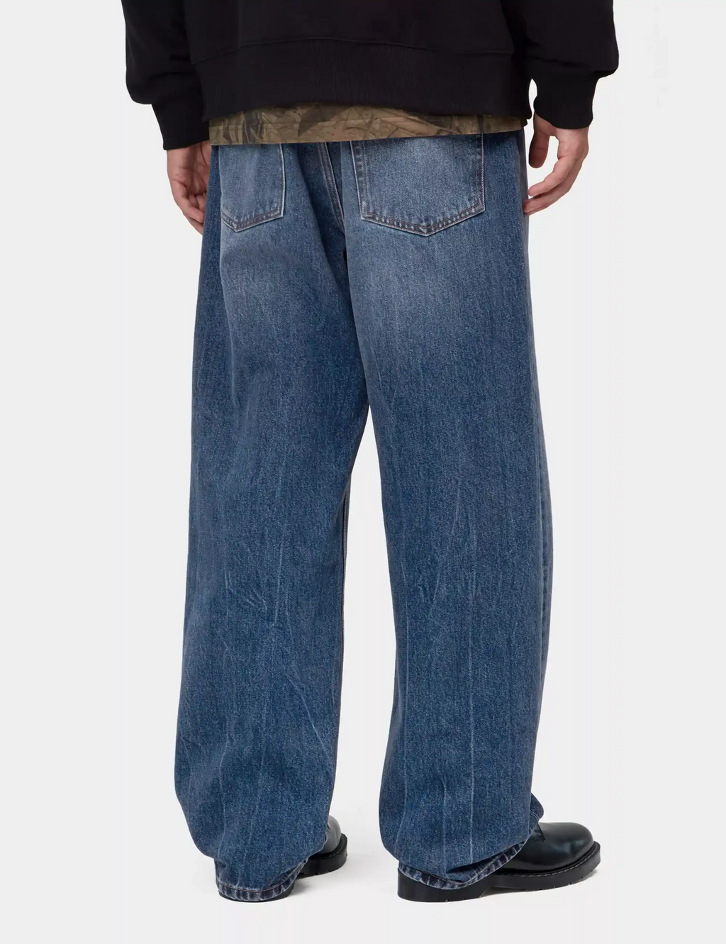 Blue wide-leg denim pant with rear yoke and back patch pockets, marble wash