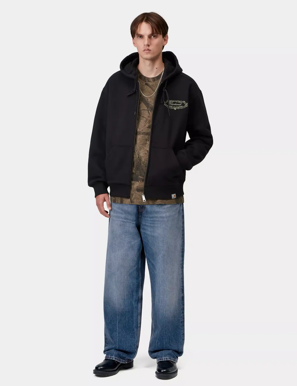 Wide-leg denim pants in light blue worn with a black hoodie and shoes