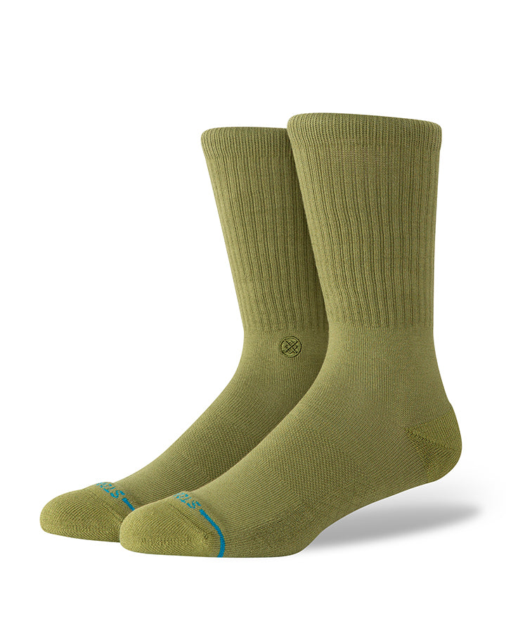 Olive crew socks with small circular logo at ankle and blue-red accents near toe