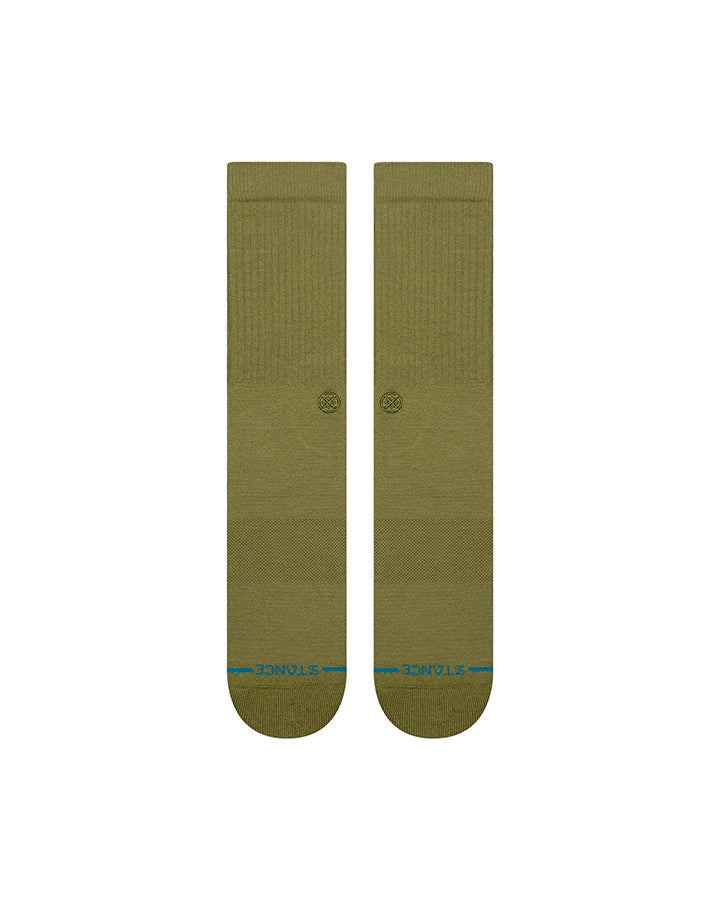 Pair of olive crew socks folded, circular logo on cuff, blue heel trim
