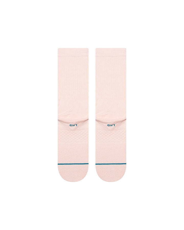 Pink crew socks with blue logo text and arch detail on foot