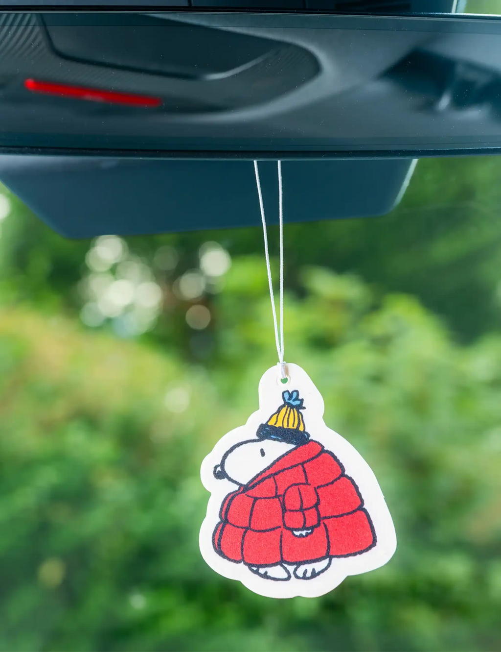 Hanging air freshener tag of Snoopy in red puffer jacket