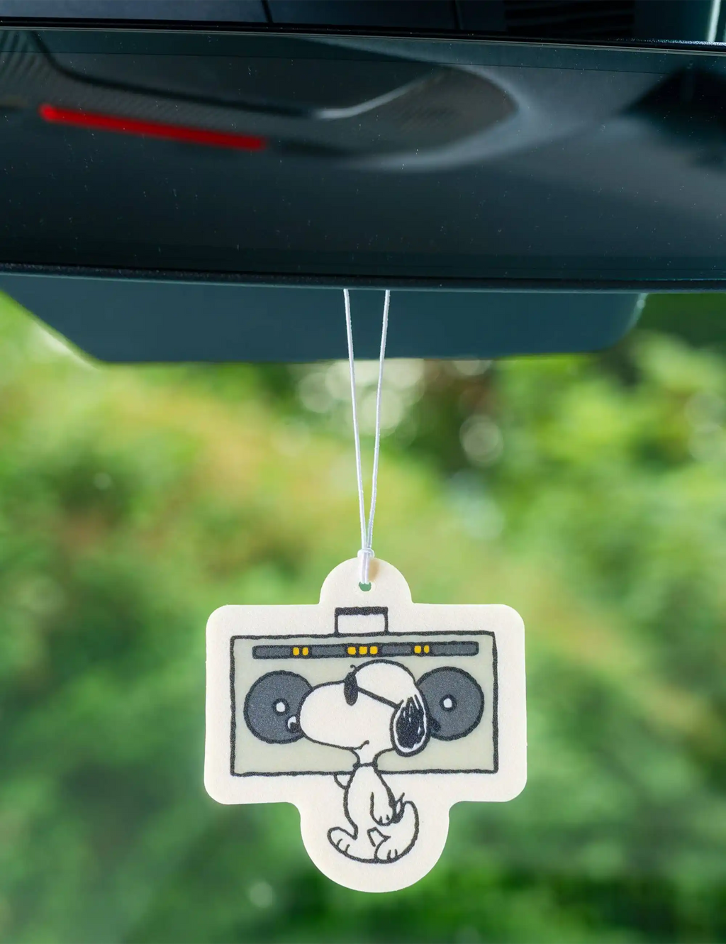 Peanuts Snoopy air freshener hanging on string, boom box graphic