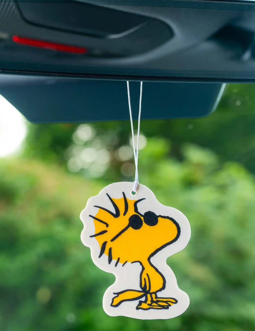 Car air freshener hanging tag with Woodstock face illustration