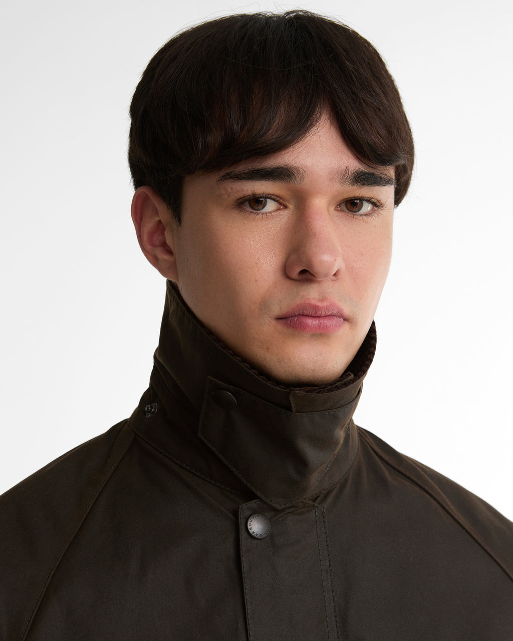 Dark brown wax jacket neckline with corduroy collar and snap detail