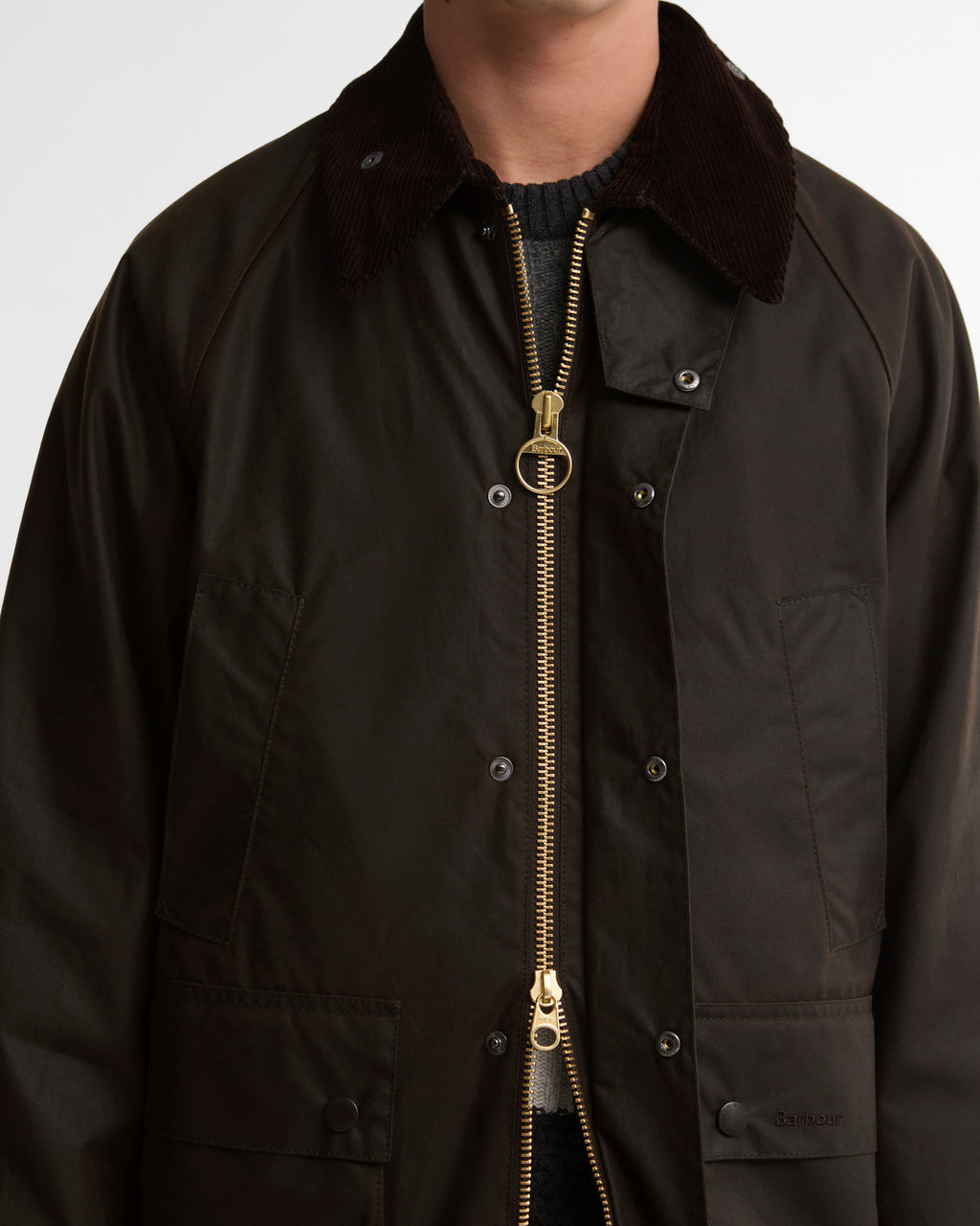 Dark brown wax jacket with corduroy collar and central zip with brass pull