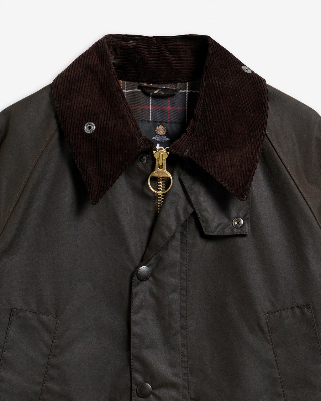 Dark brown wax jacket close-up with corduroy collar and brass zip pull