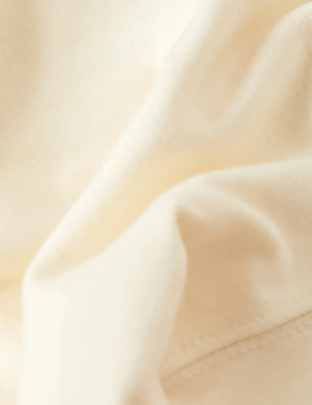 Natural T-shirt fabric close-up with soft knit texture